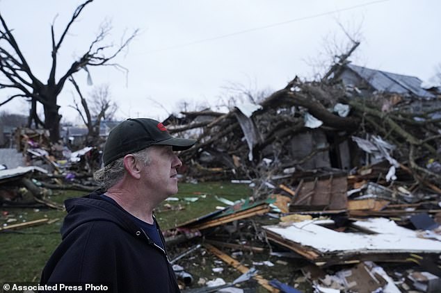 Greg McDougle walks near debris Friday, March 15, 2024 after the suspected tornado in Lakeview