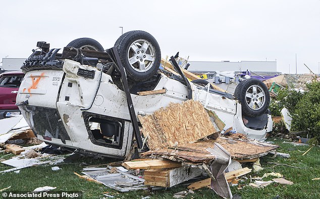 Cars are damaged from severe storms Friday, March 15, 2024, in Winchester, Ind.  Severe storms with suspected tornadoes have damaged homes and businesses in the central United States.  (Grace Hollars/The Indianapolis Star via AP)