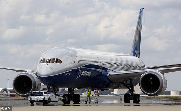 A file photo shows Boeing employees walking the company's new flagship 787-10 Dreamliner down the delivery ramp at the company's South Carolina facility