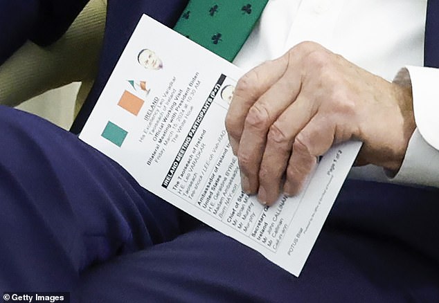 Biden flipped over his bill card, which revealed pictures and the flag of Ireland