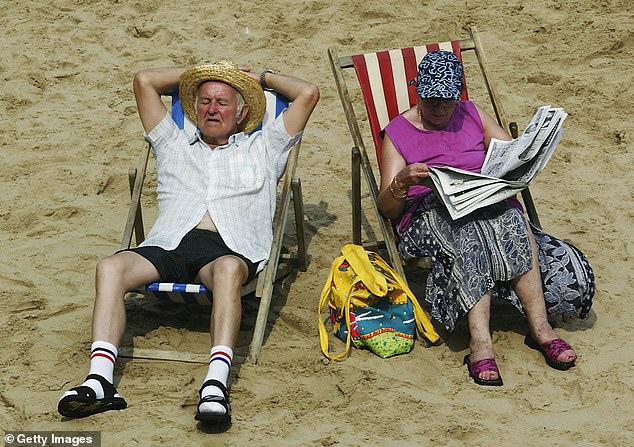 Elderly couple enjoying the sun on Blackpool beach in August 2003