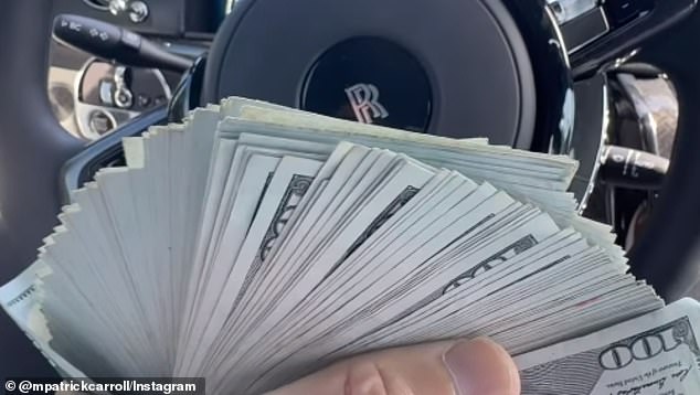 Carroll fans a bunch of hundred dollar bills while in his Rolls Royce