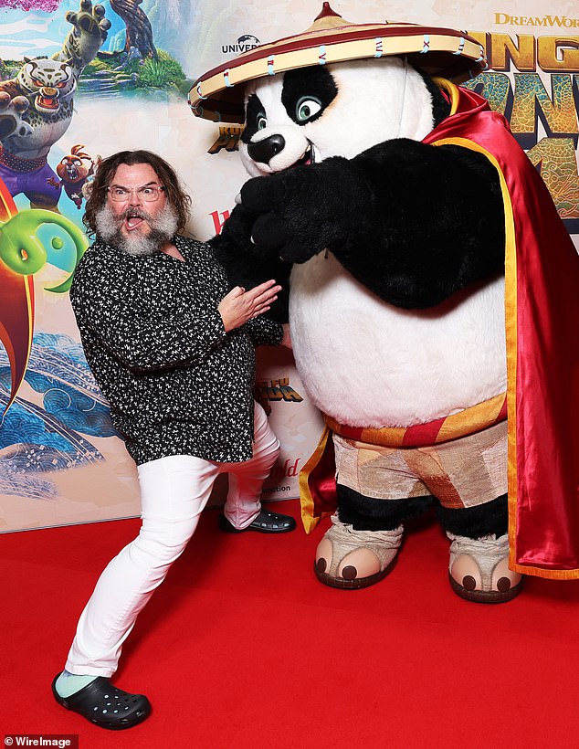 Working his angles - and showing off his agility - the comedian posed alongside a performer dressed as the main character, Master Ping Xiao Po, voiced by Black in the film