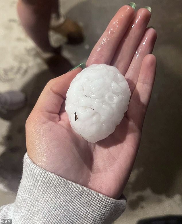 Massive chunks of hail pelted parts of Kansas and Missouri Wednesday night, bringing traffic to a standstill along Interstate 70 as storms sparked possible tornadoes and meteorologists urged residents to stay indoors