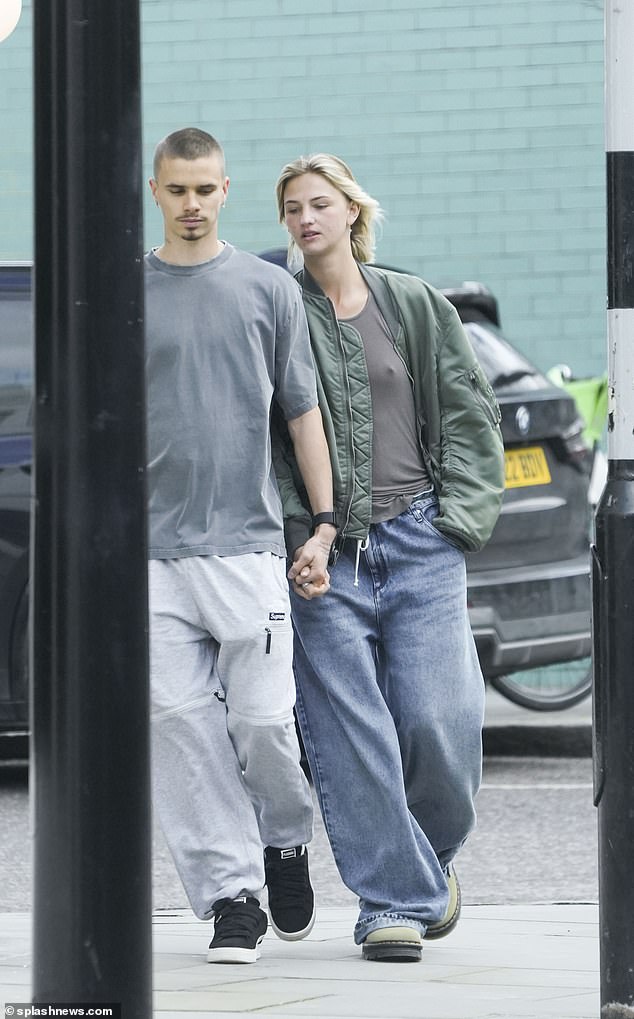 Mia appeared bare-faced for the outing as she completed the look with a light green Dr.  Martens
