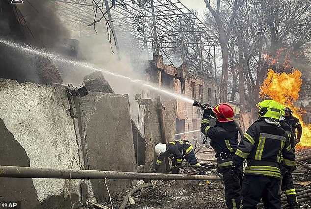 Firefighters tackle a fire amid rubble after the 'double tap' attack destroyed 'at least 10' houses in Odesa