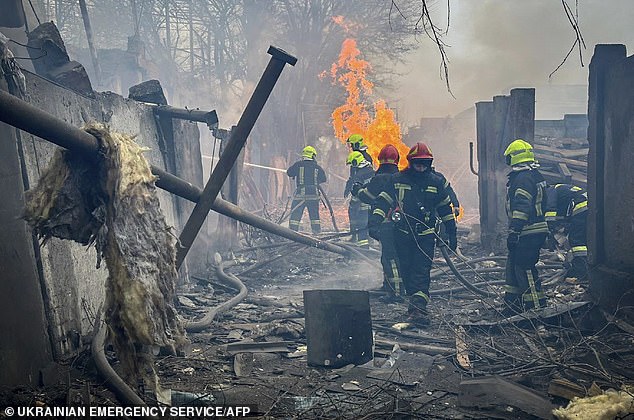 Rescue workers put out a fire at the site of a missile strike in Odesa following the March 15 attack