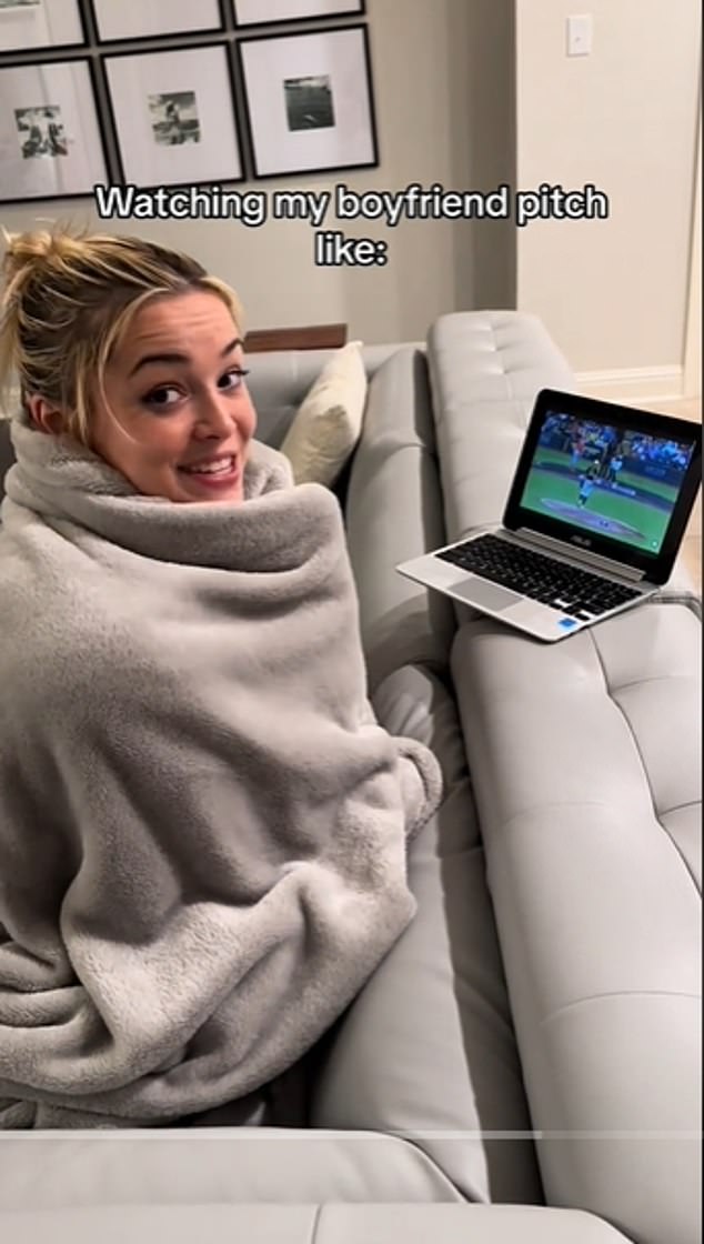 Dunne was wrapped in a blanket as he watched boyfriend Paul Skenes pitch on a laptop