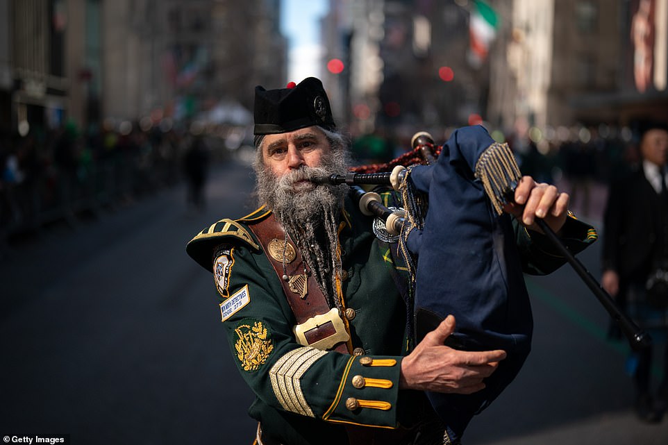 A man plays the bagpipes during the 263rd annual St Patrick's Day parade