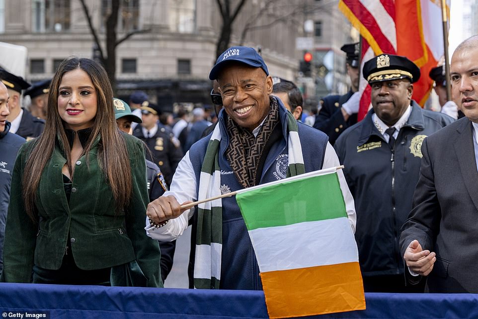 New York Mayor Eric Adams attends the St Patrick's Day Parade up 5th Ave, waving an Irish flag from the sidelines