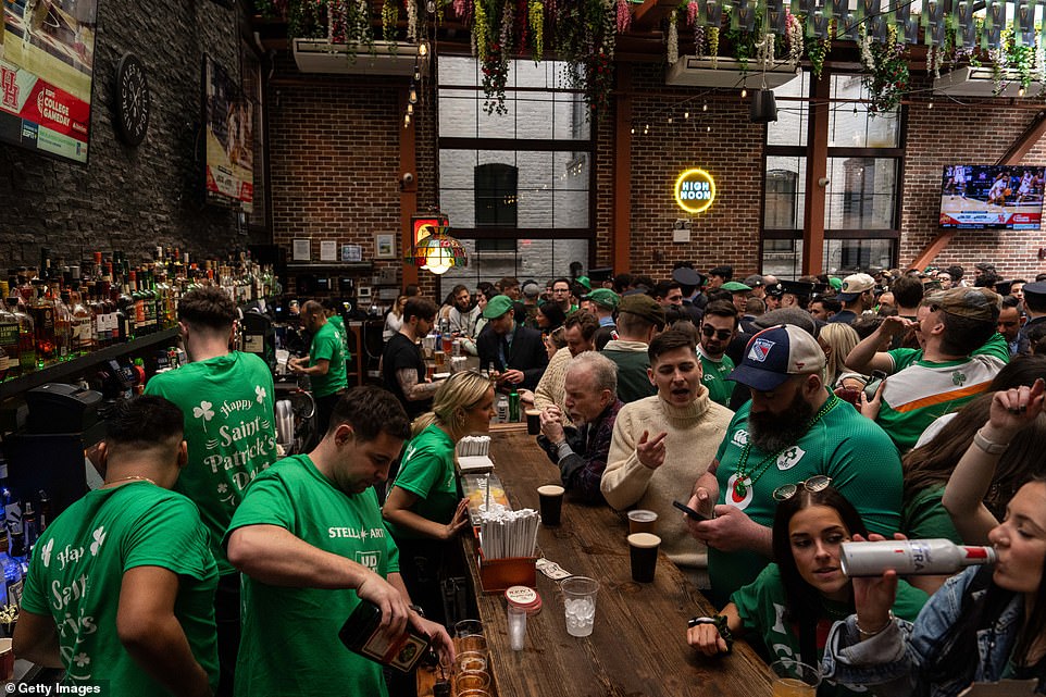People drink at The Perfect Pint bar in New York City early on St Patrick's Day