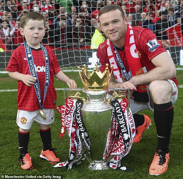 Wayne Rooney celebrates with his son Kai and the Premier League trophy in 2013
