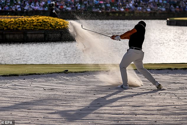 Xander Schauffele of the USA hits from a large bunker on the 16th hole during the third round