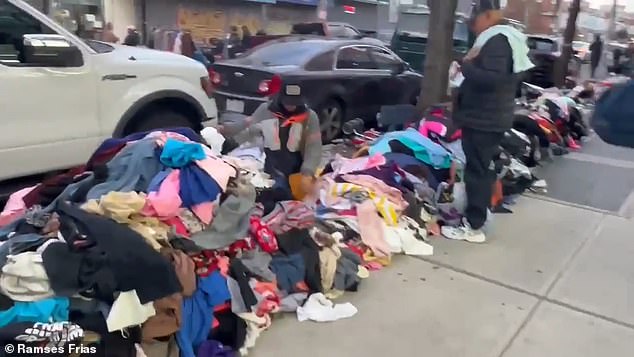 Vendors can be seen lining the streets with piles of clothes piled next to them, while others sell sneakers, toys and other miscellaneous items