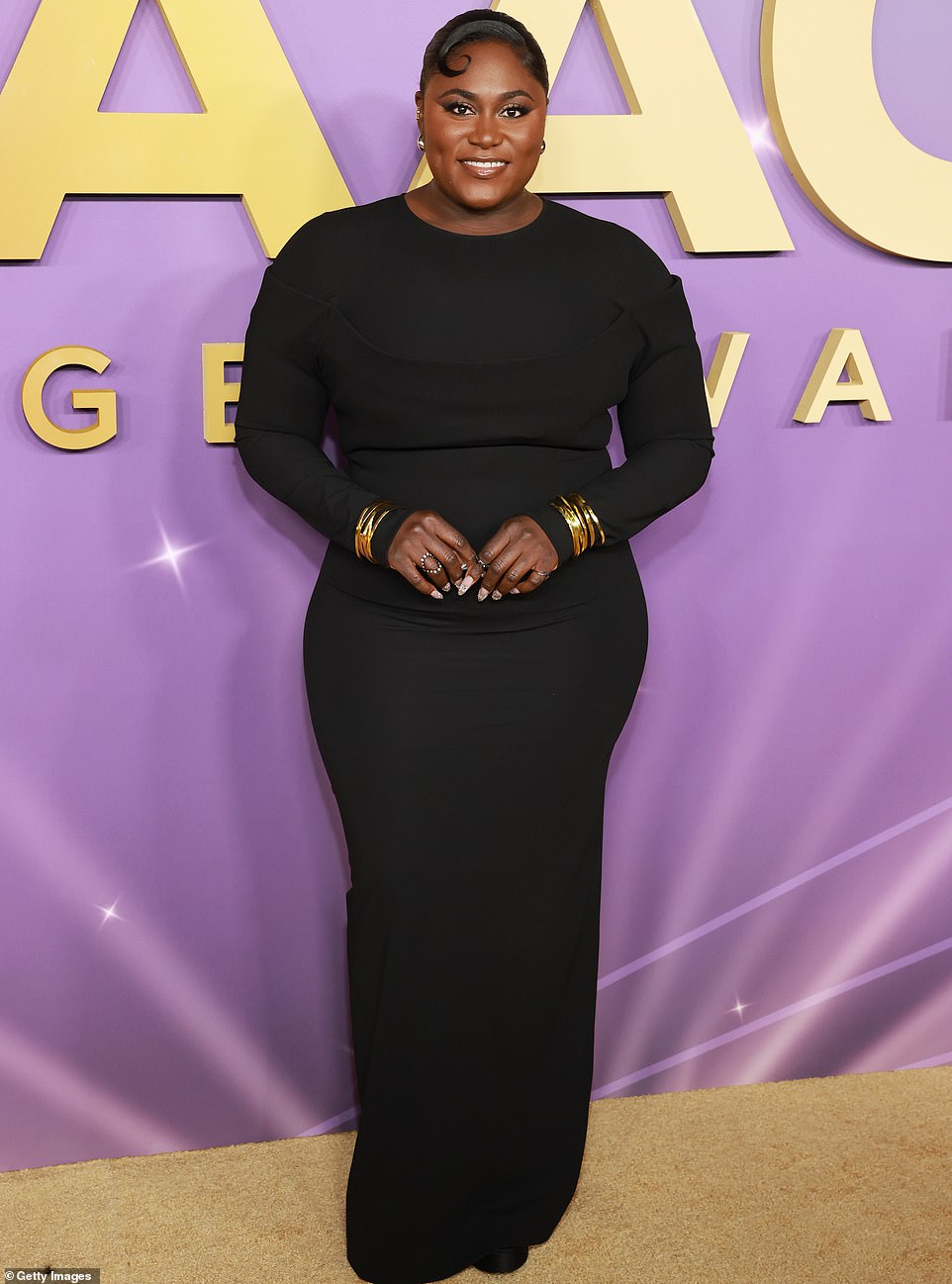 Danielle Brooks, who is also nominated for her turn in The Color Purple in a role she previously played on Broadway, modeled a simple floor-length black dress but added a splash of glitter with bangles