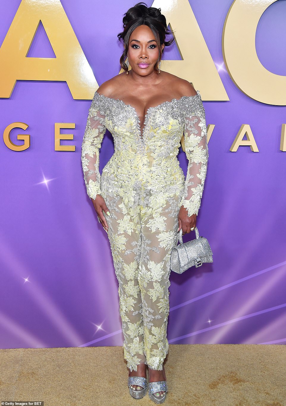 Timelessly bubbly at the age of 59, Vivica A. Fox strutted around in a tantalizing sheer floral jumpsuit that clung to her curves and flaunted her bountiful endowments