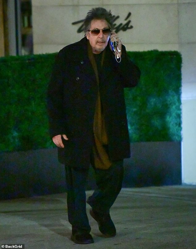 The Oscar winner looked casual in a warm black wool coat over a sweater and a pair of black joggers