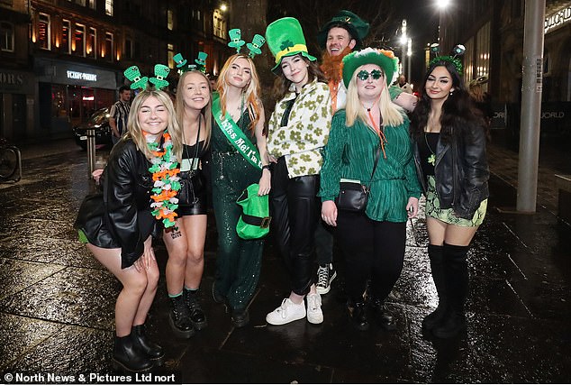 Pictured: A group of revelers dressed in green enjoy a night out in Newcastle