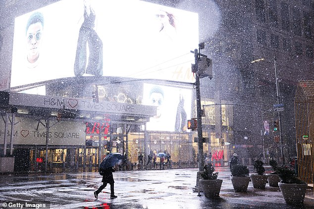 El Niño - which translates to 'little boy' in Spanish - is caused by a shift in the distribution of warm water in the Pacific Ocean around the equator. Pictured: People walk along Times Square in the middle of a winter storm in February