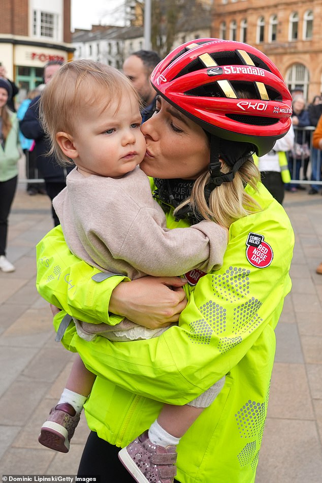 Mollie cradled her 16-month-old daughter Annabella after completing the epic challenge