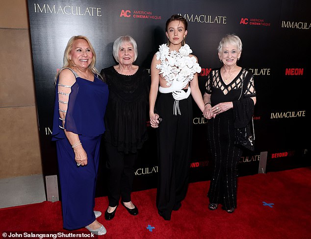 The 26-year-old actress was accompanied by two of her grandmothers and her mother Lisa (pictured left) at the Los Angeles premiere of her thriller Immaculate on Friday.