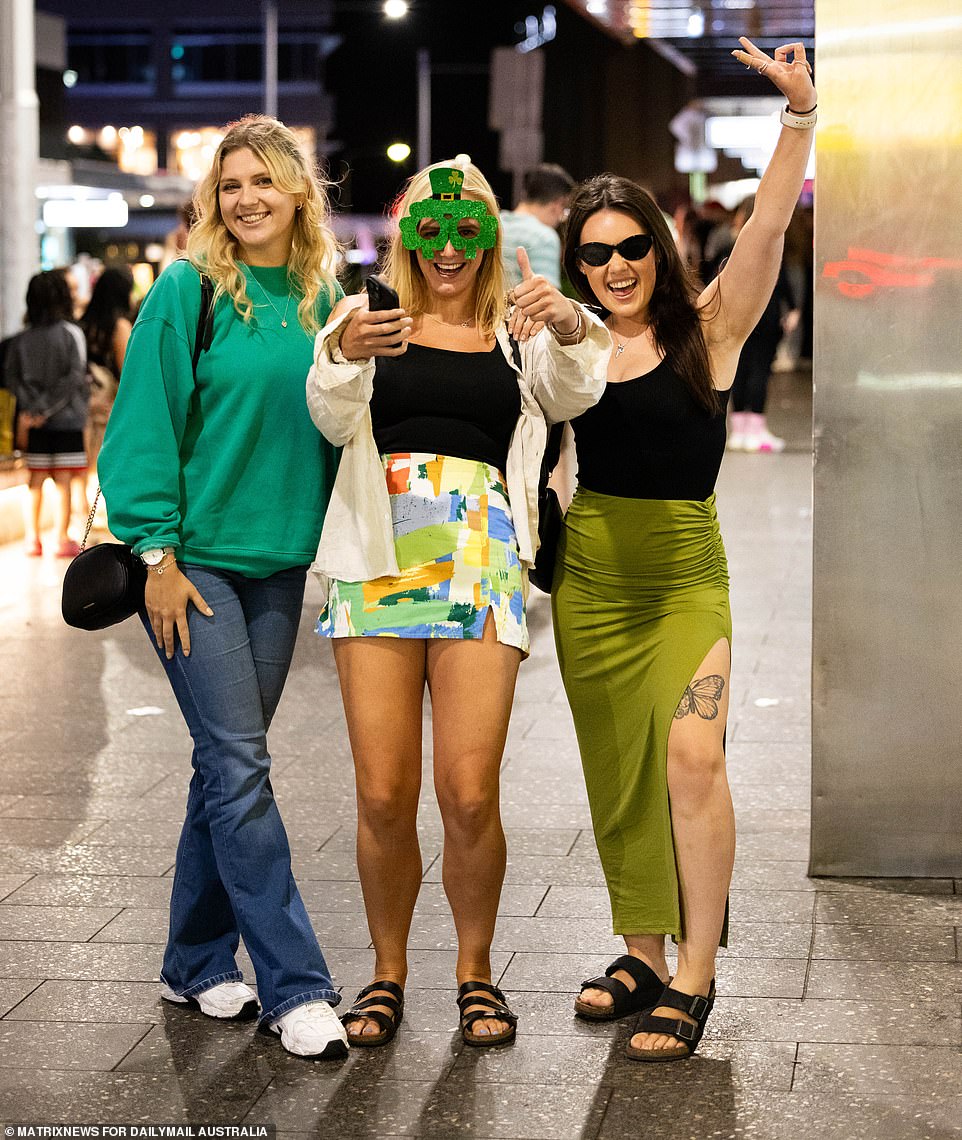 Revelers dressed in green clothing and accessorized their look with oversized novelty glasses