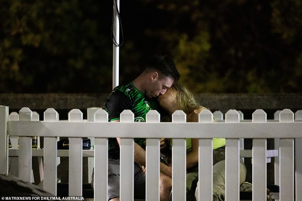 A couple are pictured sharing a quiet moment during the riotous St Patrick's Day celebrations
