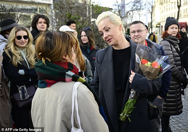 Yulia Navalnaya, widow of late Kremlin opposition leader Alexei Navalny, speaks with a woman during a demonstration near the Russian embassy in Berlin