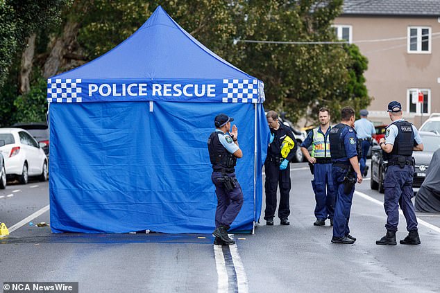 Officers are pictured processing the crime scene in Tamarama on Sunday