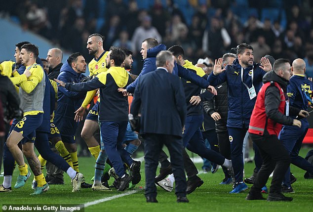 Stewards tried to protect the players as many fans forced their way onto the pitch at full time.