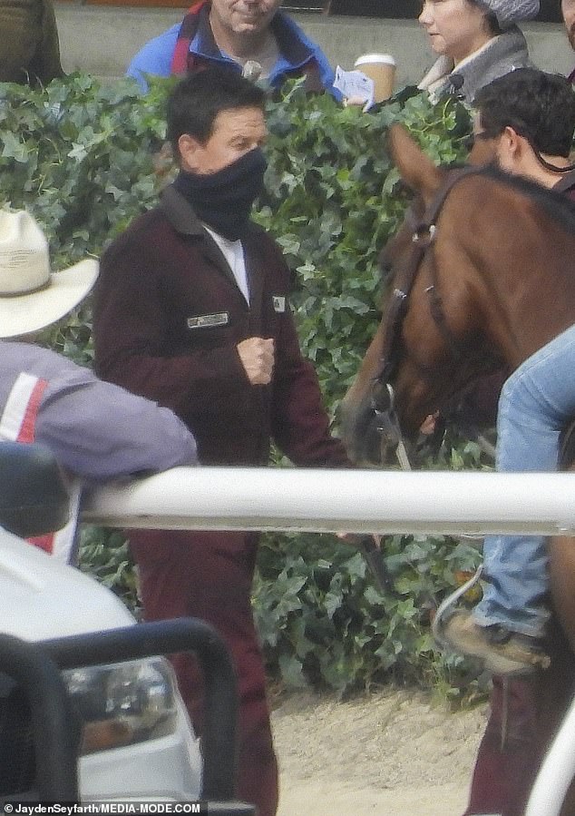 The action man was seen filming scenes alongside jockeys and racehorses at the Bankstown City Paceway.