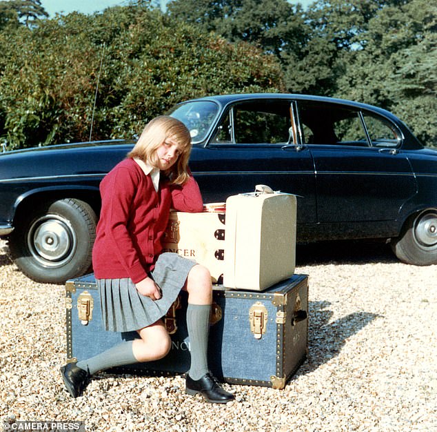 Diana told her father she didn't want to go to boarding school, but instead he took this photo of his daughter sitting on a trunk in her pleated skirt and red cardigan school uniform.