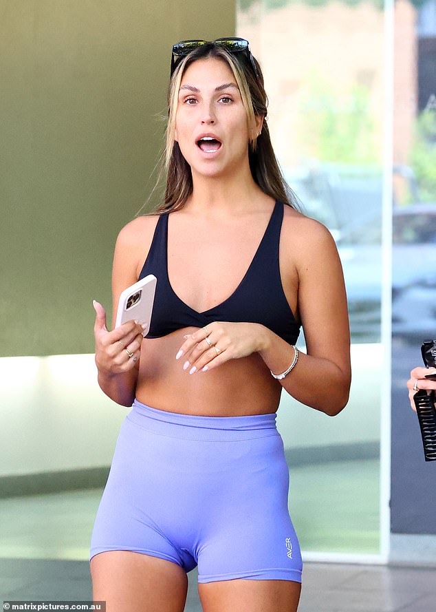 Personal trainer Sara turned up the heat in a black crop top paired with purple exercise shorts, both of which showed off her athletic figure.