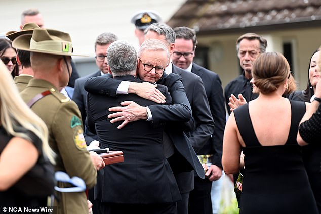 Prime Minister Anthony Albanese was among the mourners. Above, he kisses Joel Fitzgibbon