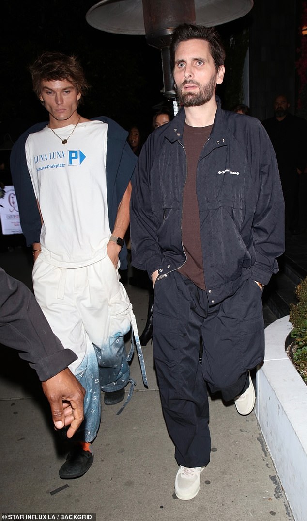 He threw on a black jacket over a brown T-shirt and paired it with oversized cargo pants.  The reality star donned a pair of cream-colored sneakers to complete her look.  He was seen leaving the restaurant alongside his friend, model Jordan Barrett, 27.