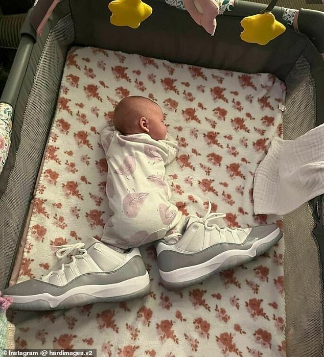 This baby looks like he has gigantic feet when in reality the big shoes were placed inside the crib