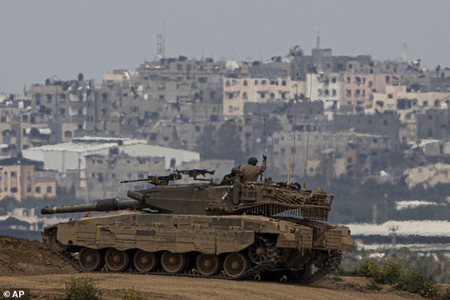 An Israeli soldier atop a tank on the border with the Gaza Strip, southern Israel, Sunday March 17.