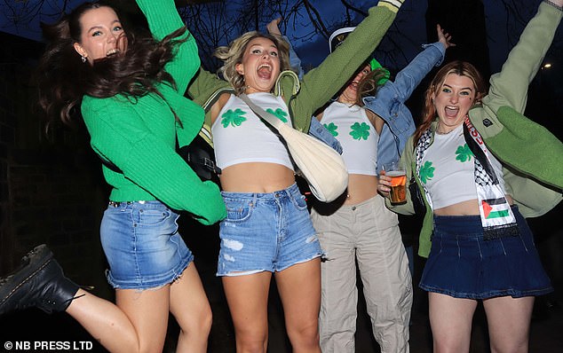 LEEDS: Four students jump for joy in green shamrock-themed outfits