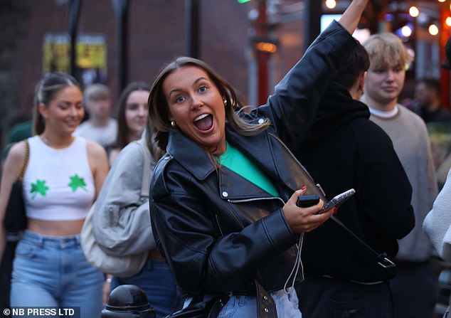 LEEDS: An excited woman poses for a photo as revelers dressed in shamrock-themed outfits enjoy the festivities