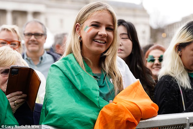 LONDON: a woman dressed in an Irish flag smiles as the parade passes