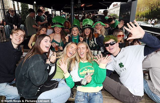 NEWCASTLE: Crowds of revelers wearing leprechaun hats and green costumes strike a pose