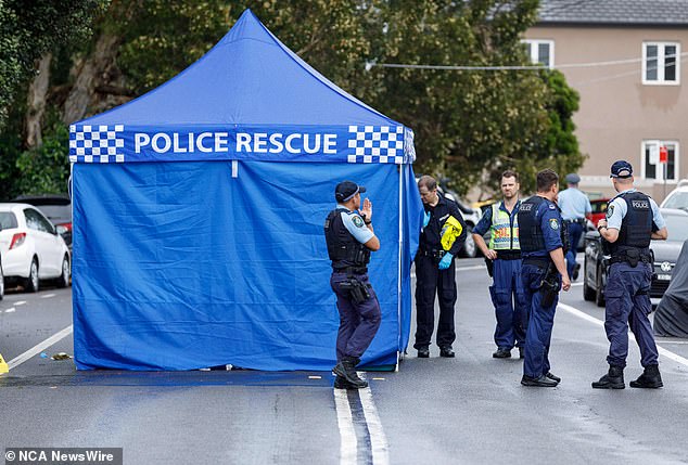 Police officers are pictured processing the crime scene in Tamarama on Sunday following the alleged hit-and-run.