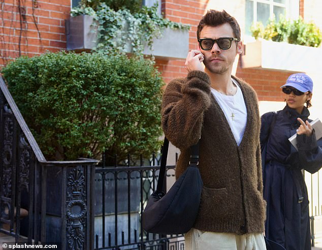 Harry looked effortlessly chic wearing a brown cashmere cardigan from The Row, over a white t-shirt with cream trousers.