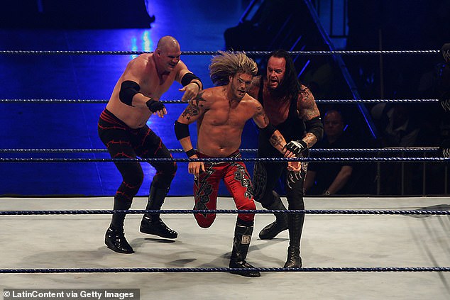 He had feuds with a number of legends before calling it quits - but he's made sporadic appearances since (pictured with Kane, left, and Edge, center).