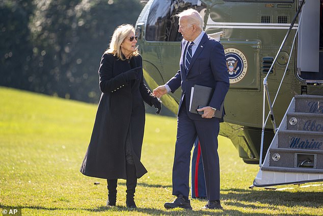 President Joe Biden, right, and first lady Jill Biden arrive at the White House on February 19, 2024 with Biden wearing chunky black sneakers with a blue suit.