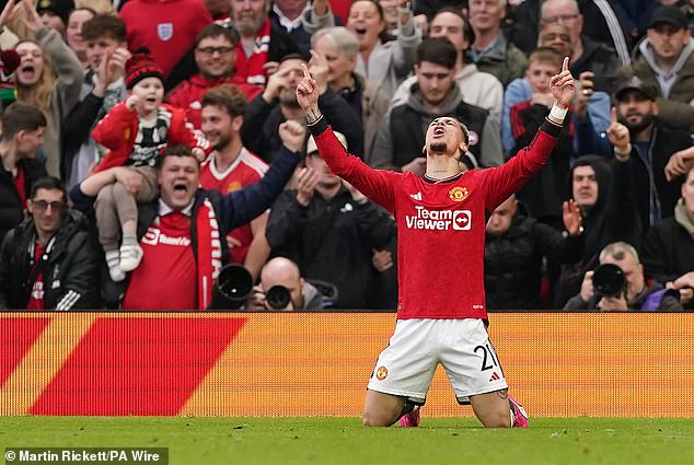 Antony celebrates outside the Stretford End after scoring United's equalizer at 2-2