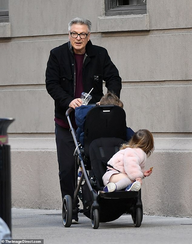 The father of eight - who shares seven of his children with his wife Hilaria, 40, carried a drink while chatting to his son and daughter while pushing a stroller