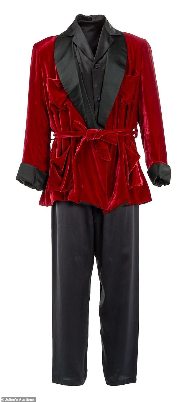 Hefner's ensemble includes his burgundy tuxedo jacket, silk pajamas and slippers as well as a copy of the Time Magazine edition featuring the Playboy founder, paying tribute to Hefner after his death.