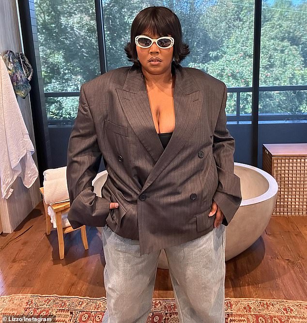 Lizzo, born Melissa Viviane Jefferson, also wore a pair of loose blue jeans offset by white shoes.