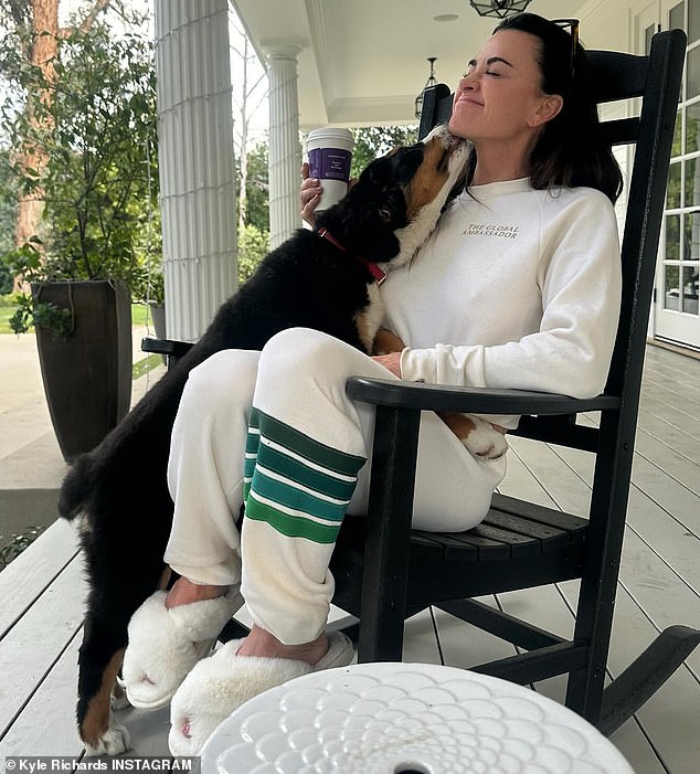 In the snaps, the 55-year-old reality TV personality relaxed in a rocking chair while her four-legged friend gave her a kiss.